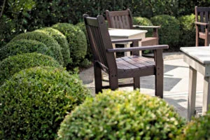 7 Principles Of Landscape Design; Repetition; Round bushes surround outdoor wooden chairs