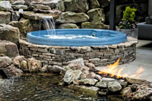 7 Principles Of Landscape Design; Focalization; Round stone water feature with fire in foreground